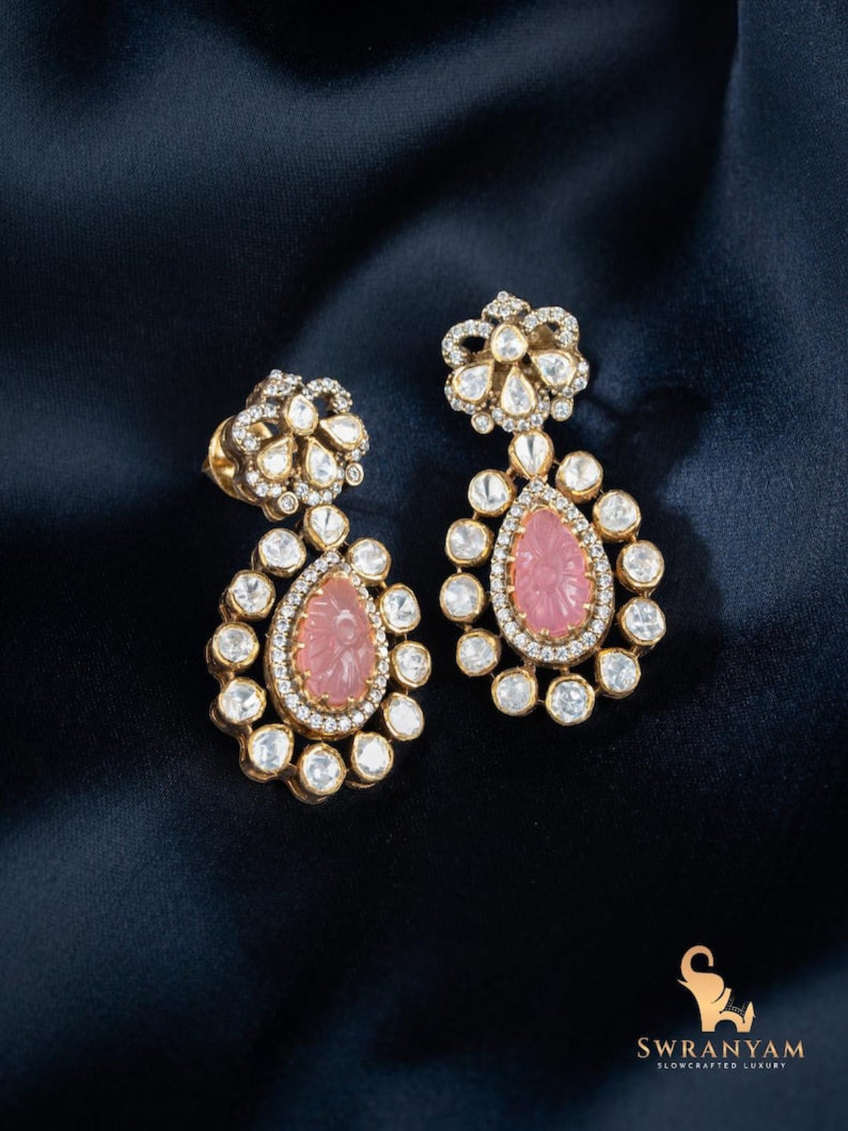 Swranyam 92.5 silver Moissanite Polki dangler earrings with pink stone, on black fabric background