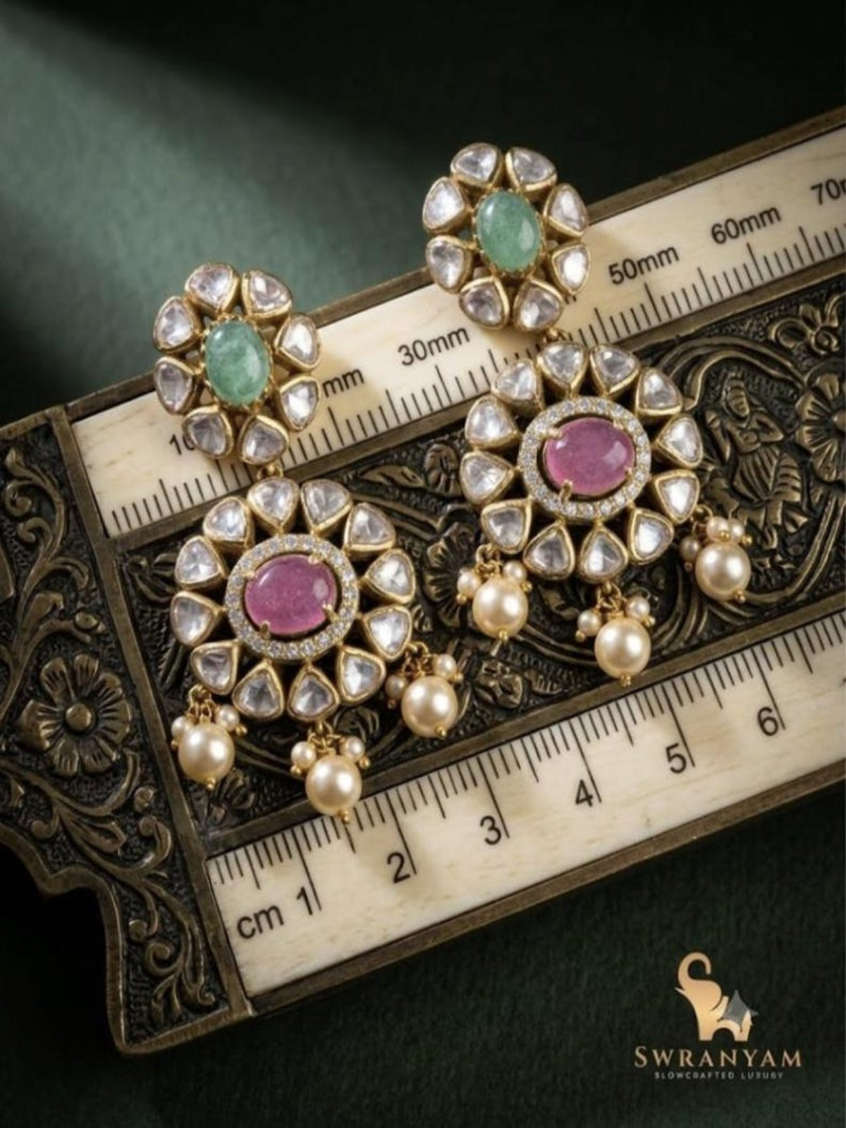 Swranyam silver earrings displayed on jewelry box with measurement ruler