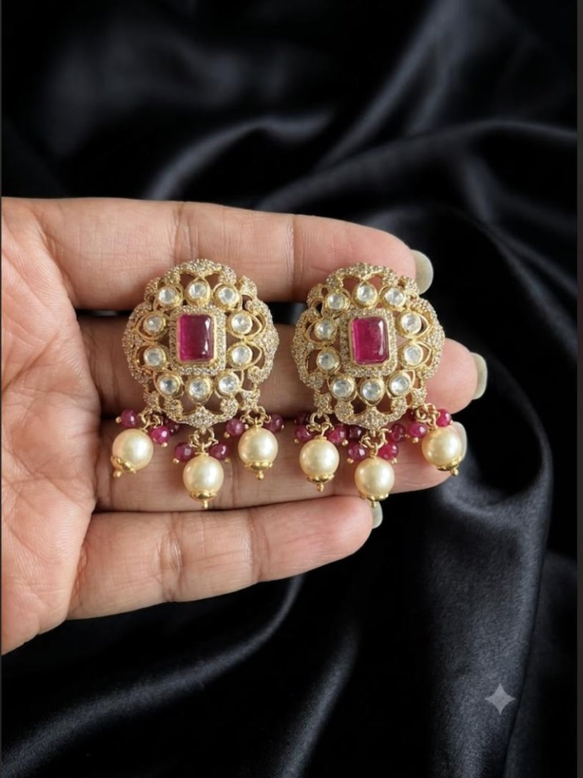 Model holding Swranyam 925 silver ruby pota stone earrings with pearl drops