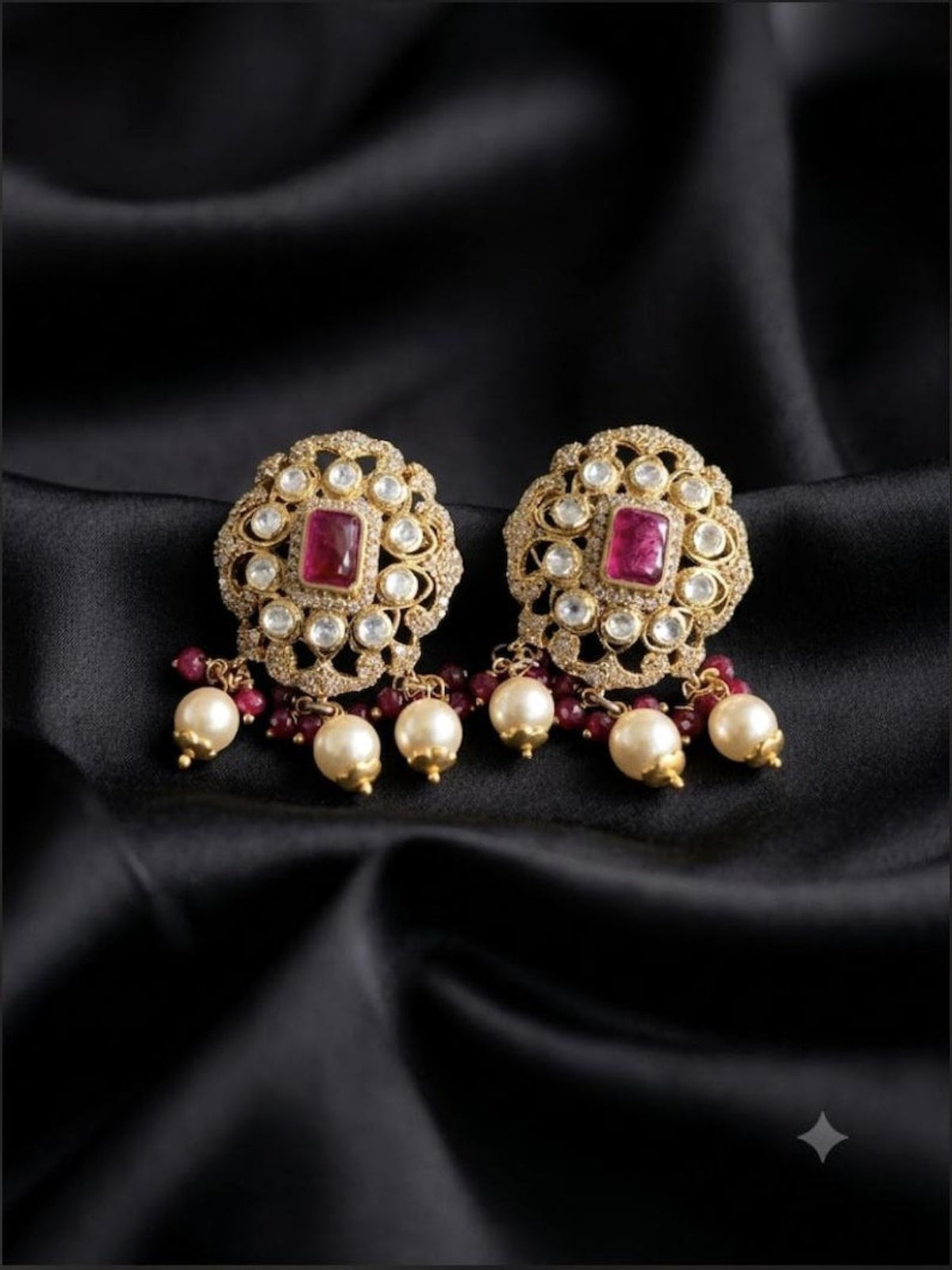 Swranyam 925 sterling silver earrings with ruby pink pota stone and pearl drops, on black fabric background