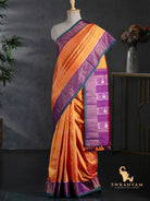 Orange Pochampally twill ikat silk saree with purple woven border and teal edge draped on a mannequin