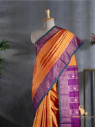 Close up of orange zigzag ikat body and purple gold woven border on Pochampally twill ikat silk saree